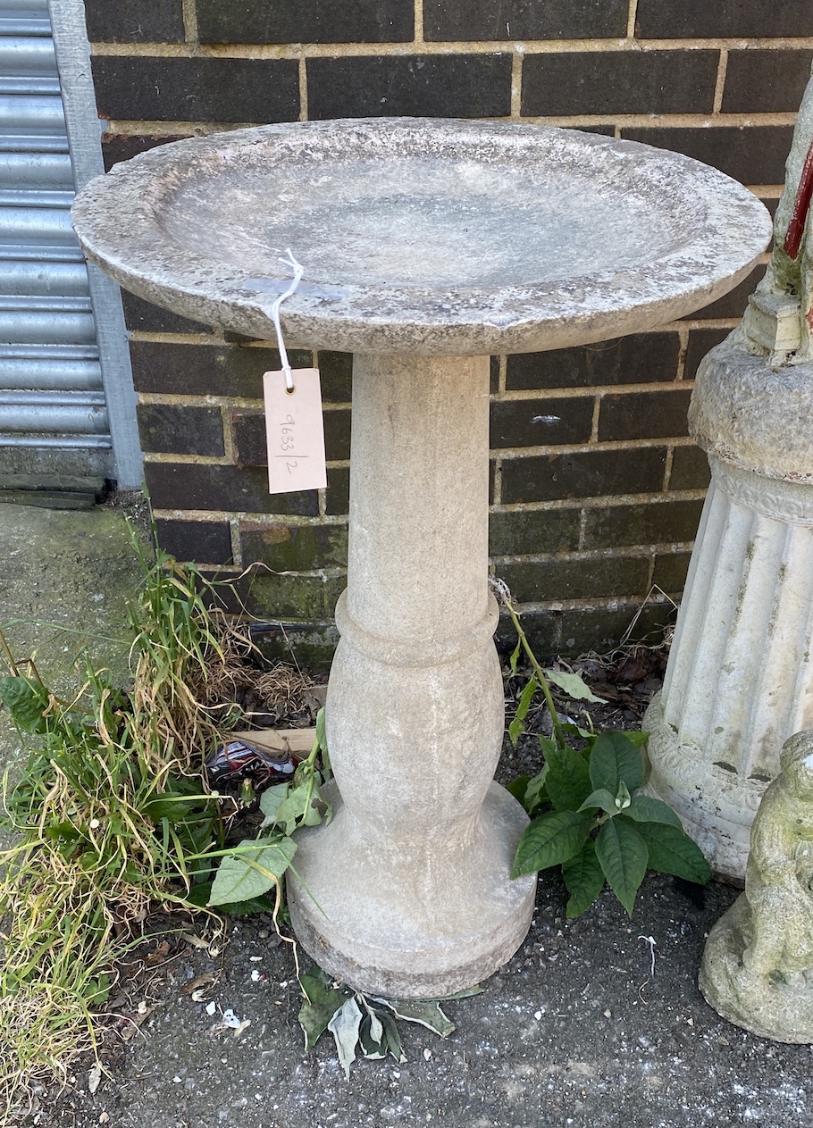 A circular reconstituted stone garden bird bath, diameter 49cm, height 76cm